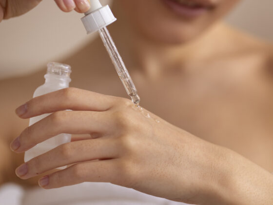 Women applying a skincare serum on her hand skin