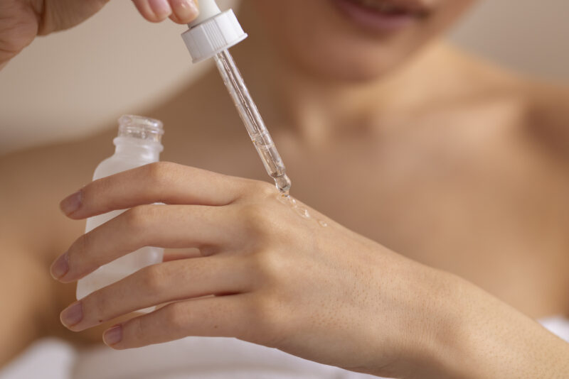 Women applying a skincare serum on her hand skin