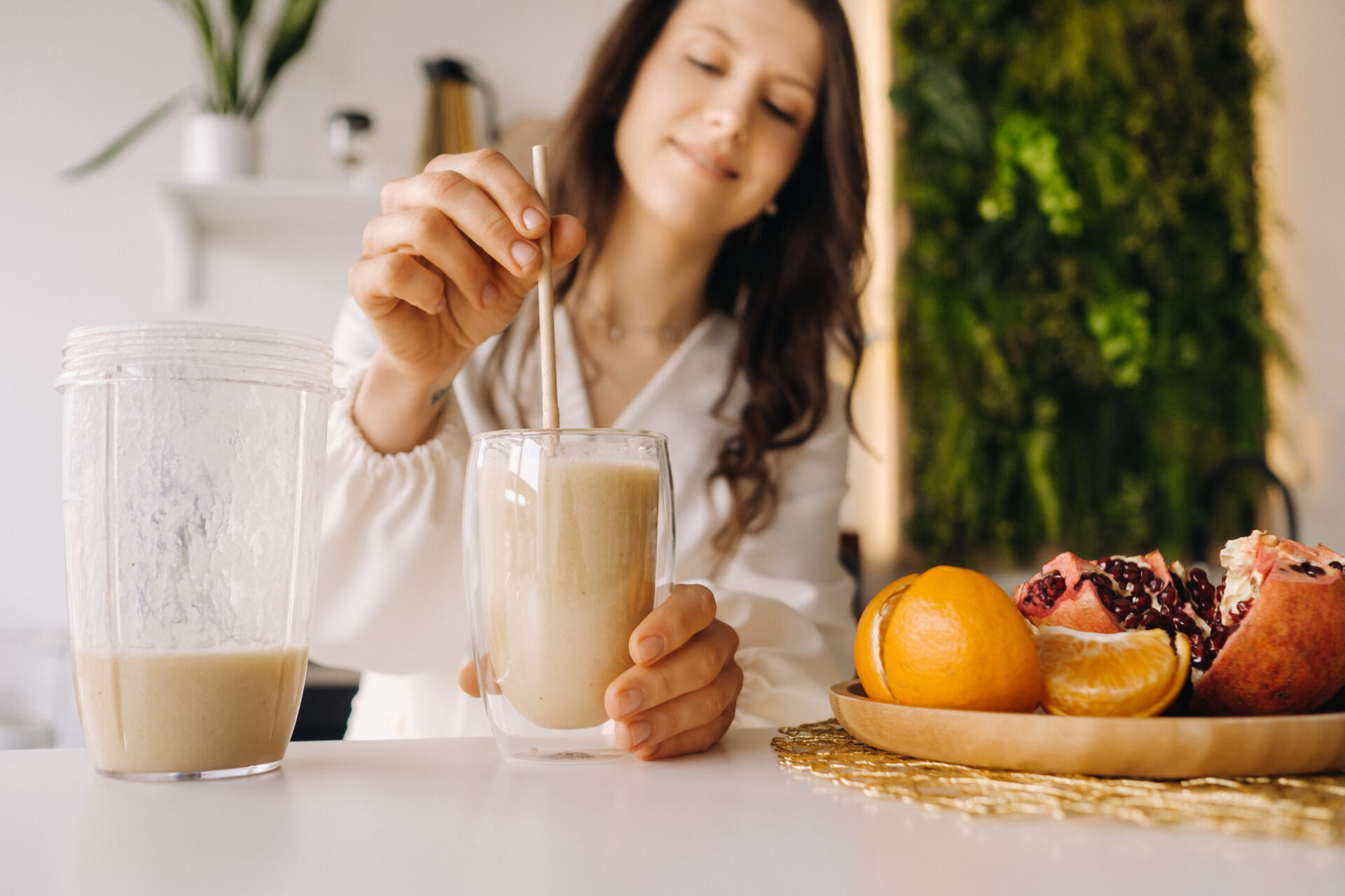 close up of Woman hand about to drink her beauty smoothie