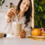 close up of Woman hand about to drink her beauty smoothie