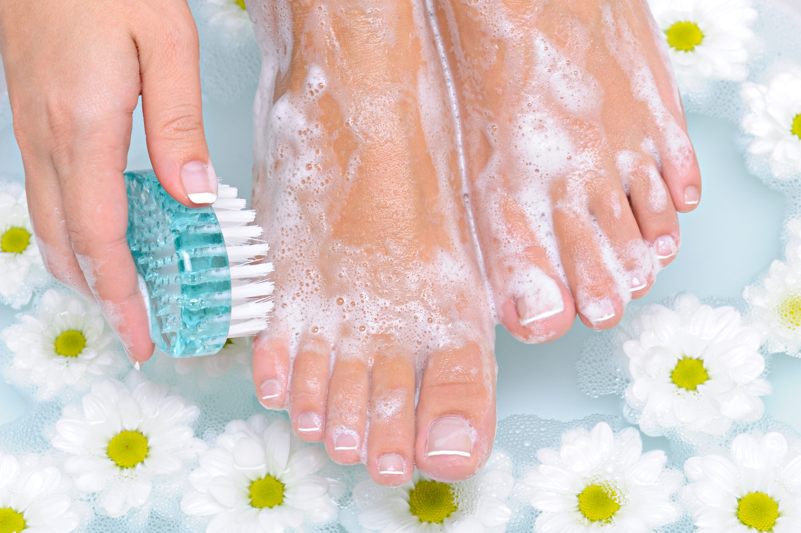 women exfoliating her feet and following the smooth feet summer tips