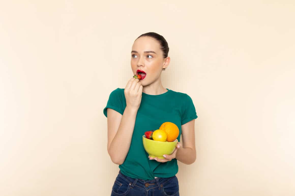 Young Attractive Woman Holding a Plate With Fruits