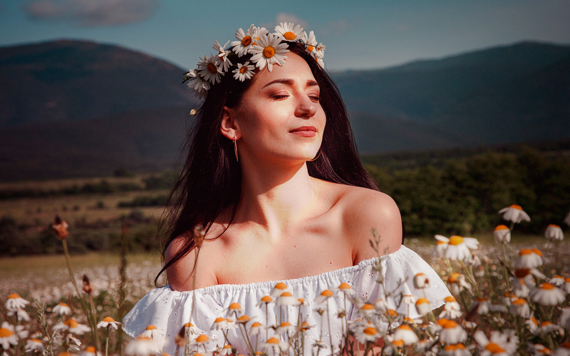 beautiful woman showing her beauty in a daisy field with flowers after embracing Spring Skin Renewal Techniques